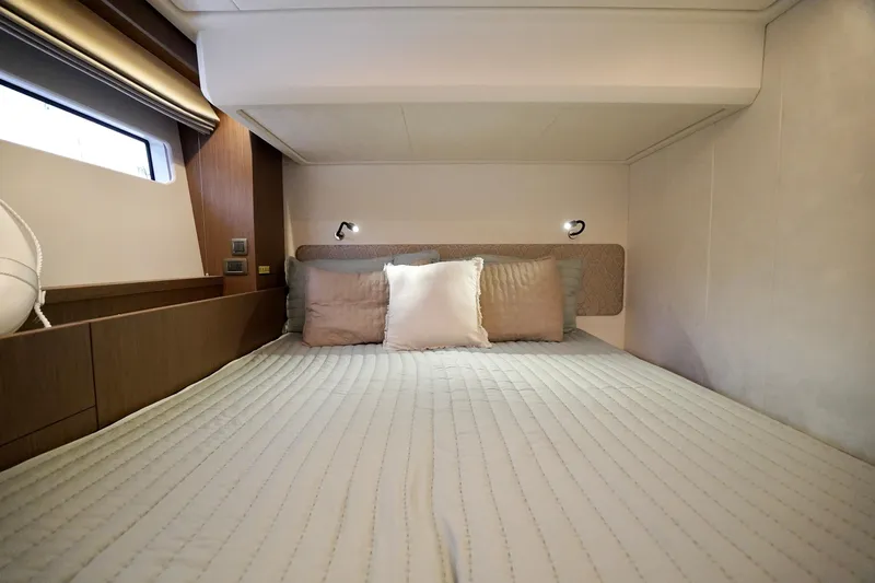  Yacht Photos Pics Luxurious cabin interior of 2026 Prestige F4.9 yacht with cozy bedding and modern lighting.