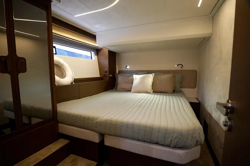  Yacht Photos Pics Luxurious bedroom interior of 2026 Prestige F4.9 yacht with cozy bedding and modern design.