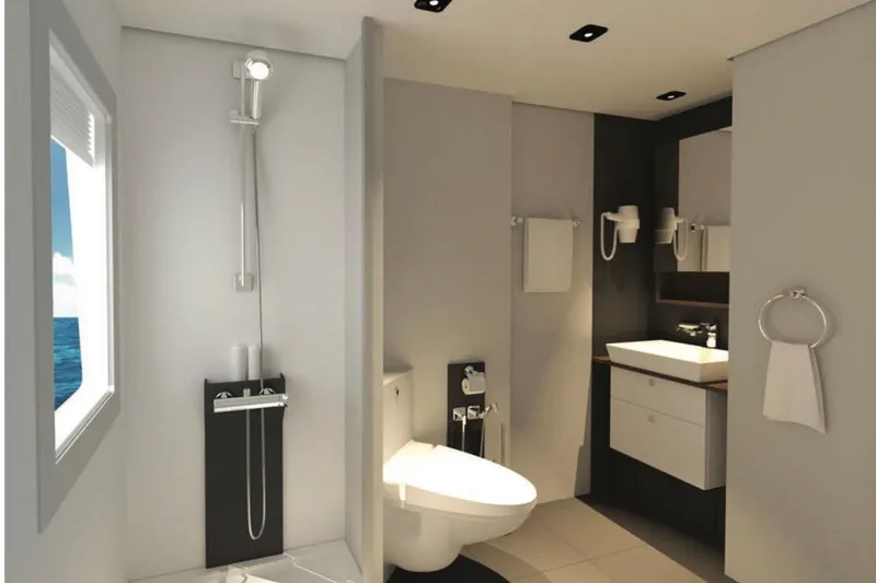 Nirvana Yacht Photos Pics Modern bathroom with shower, toilet, and sink, featuring sleek design and ocean view window.