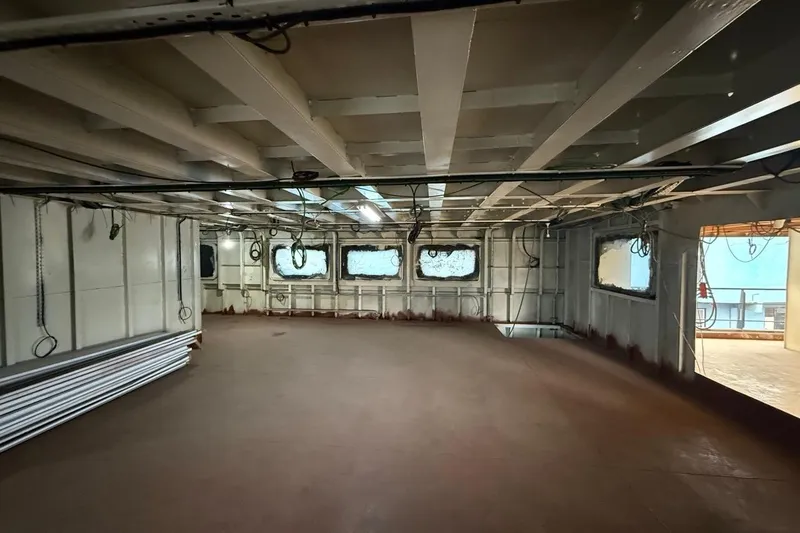 Nirvana Yacht Photos Pics Interior of a 2027 Soyaslan Custom ship, featuring spacious, unfinished room with windows.
