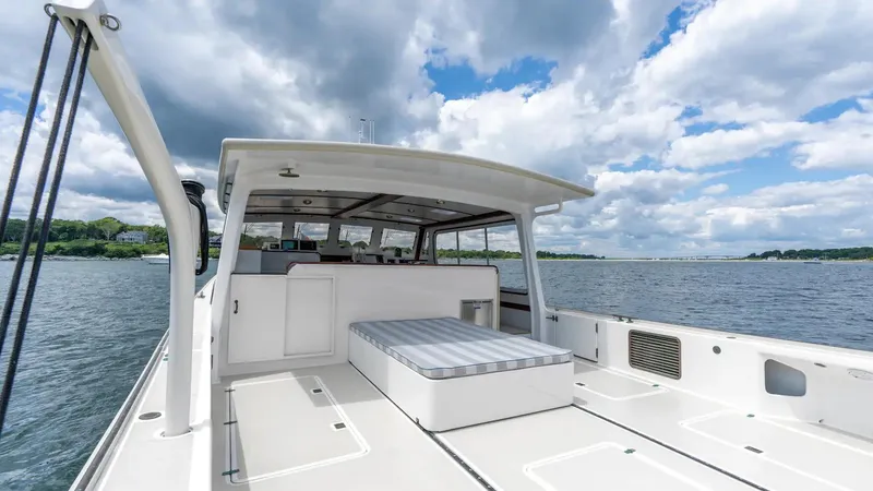 Stella Rose Yacht Photos Pics 2021 Mussel Ridge Downeast boat on water under cloudy sky.