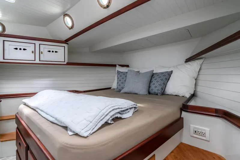Stella Rose Yacht Photos Pics Cozy cabin interior of 2021 Mussel Ridge Downeast boat with bed and pillows.