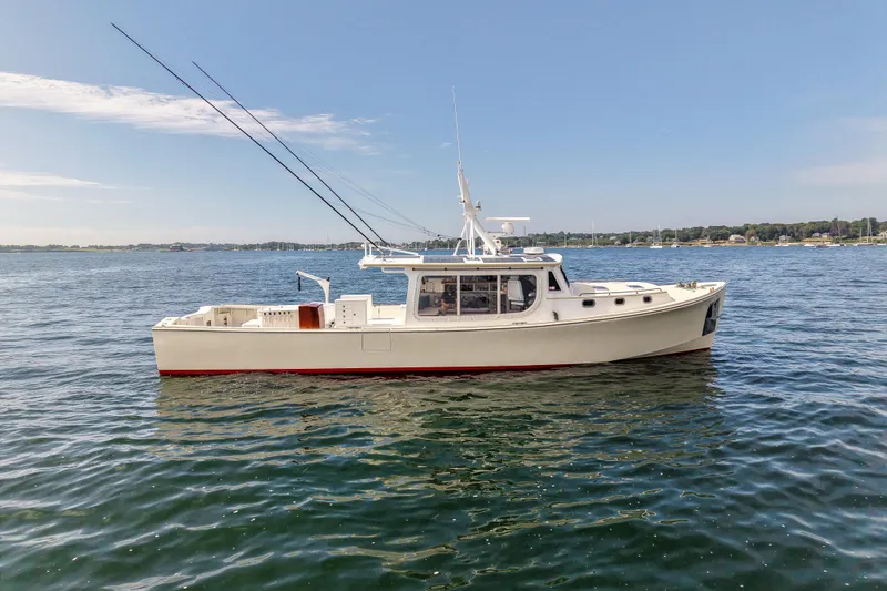 Stella Rose Yacht Photos Pics 2021 Mussel Ridge Downeast boat on calm water under clear sky.