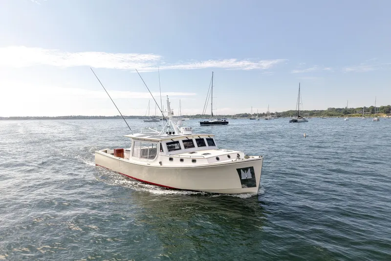 Stella Rose Yacht Photos Pics 2021 Mussel Ridge Downeast boat cruising on a calm sea under a clear sky.