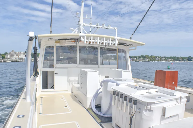Stella Rose Yacht Photos Pics 2021 Mussel Ridge Downeast boat on water, featuring spacious deck and fishing equipment.