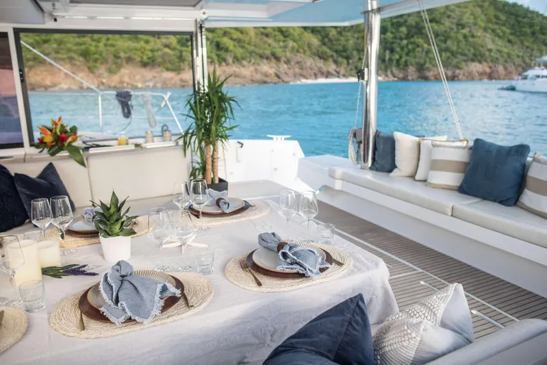 Ad Astra Yacht Photos Pics Luxurious Bali 5.4 yacht interior with elegant dining setup, ocean view, and plush seating, 2020 model.
