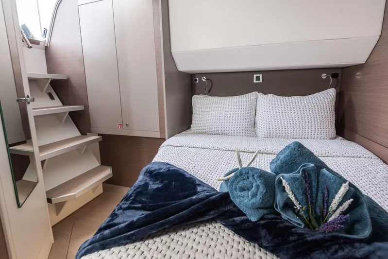Ad Astra Yacht Photos Pics Cozy bedroom in 2020 Bali 5.4 yacht with elegant bedding and decorative towels.
