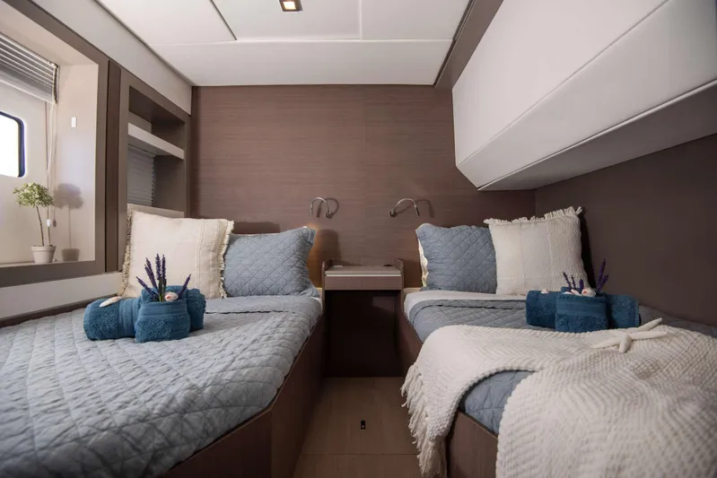 Ad Astra Yacht Photos Pics Luxurious twin cabin interior on 2020 Bali 5.4 yacht, featuring cozy bedding and elegant decor.