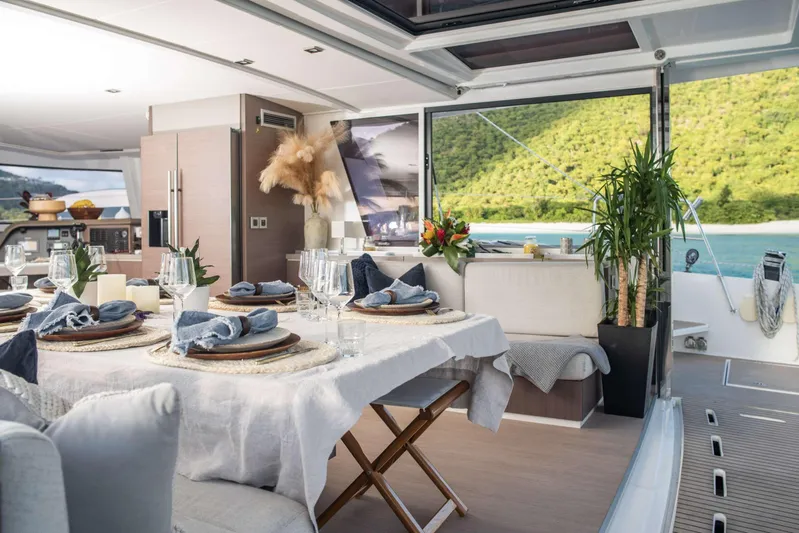 Ad Astra Yacht Photos Pics Luxurious Bali 5.4 yacht interior with elegant dining setup, scenic ocean view, and modern decor.