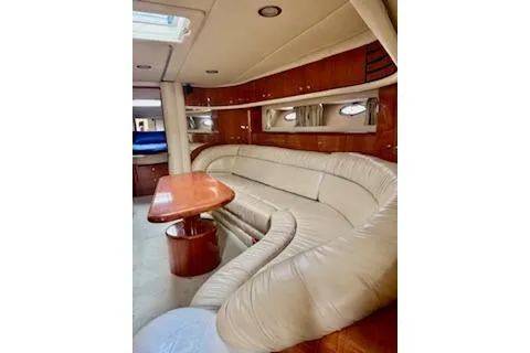 Play It Again Yacht Photos Pics Interior of 2001 Sea Ray Sundancer 540 yacht with plush seating and wooden table.