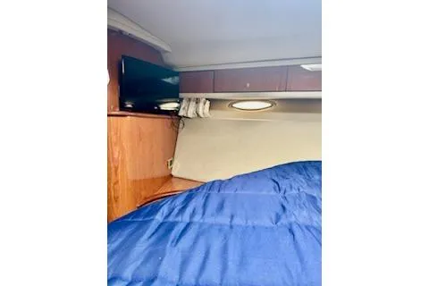 Play It Again Yacht Photos Pics 2001 Sea Ray Sundancer 540 cabin interior with blue bedding and wall-mounted TV.