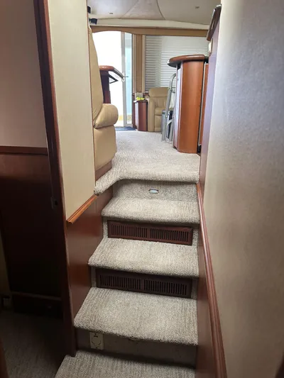  Yacht Photos Pics Interior stairs of a 2006 Silverton 48 Convertible yacht with carpeted steps.