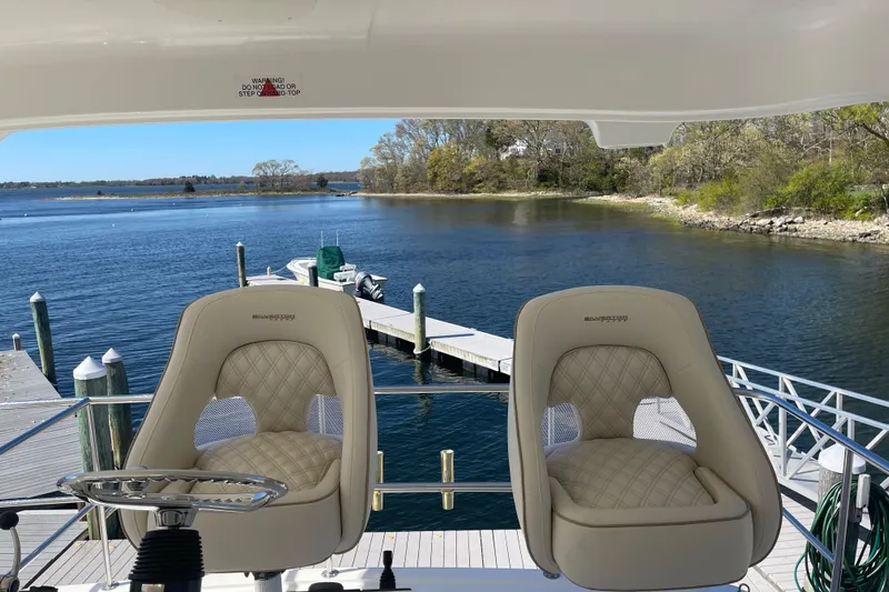  Yacht Photos Pics 2006 Silverton 48 Convertible yacht with helm chairs at a dock.