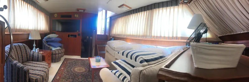 Wanderer Yacht Photos Pics Interior of 1981 Hatteras 48 Motor Yacht with cozy seating and striped cushions.