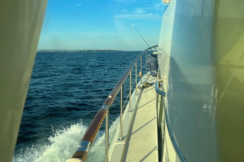 Wanderer Yacht Photos Pics 1981 Hatteras 48 Motor Yacht cruising on open sea under clear blue sky.
