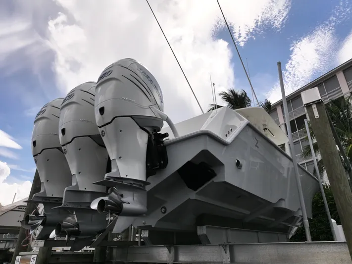 Yacht Photos Pics 2017 SeaVee 370z boat with triple outboard engines, docked under a cloudy sky.