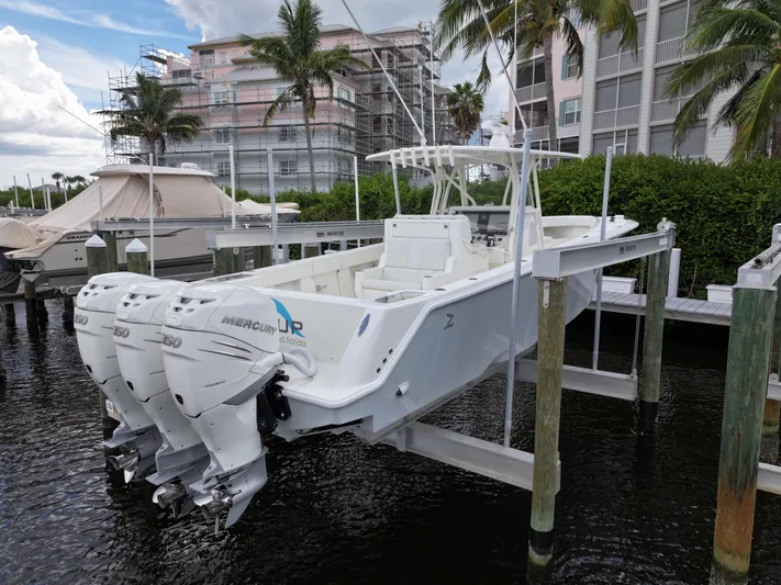  Yacht Photos Pics 2017 SeaVee 370z boat with triple Mercury engines docked near palm trees.