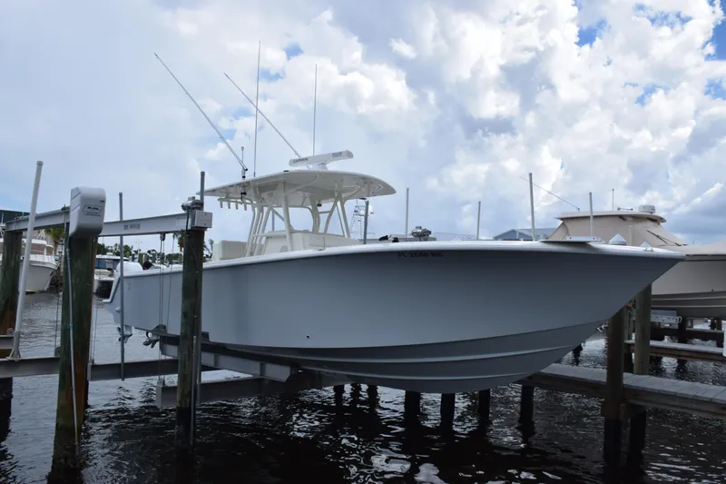  Yacht Photos Pics 2017 SeaVee 370z boat docked on lift under cloudy sky.