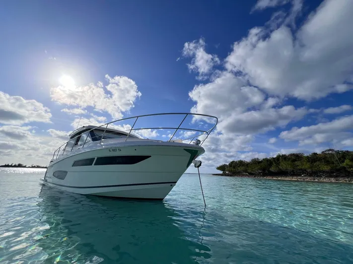 "seadancer" Yacht Photos Pics 2022 Regal 38 XO yacht anchored in clear blue water under a sunny sky.