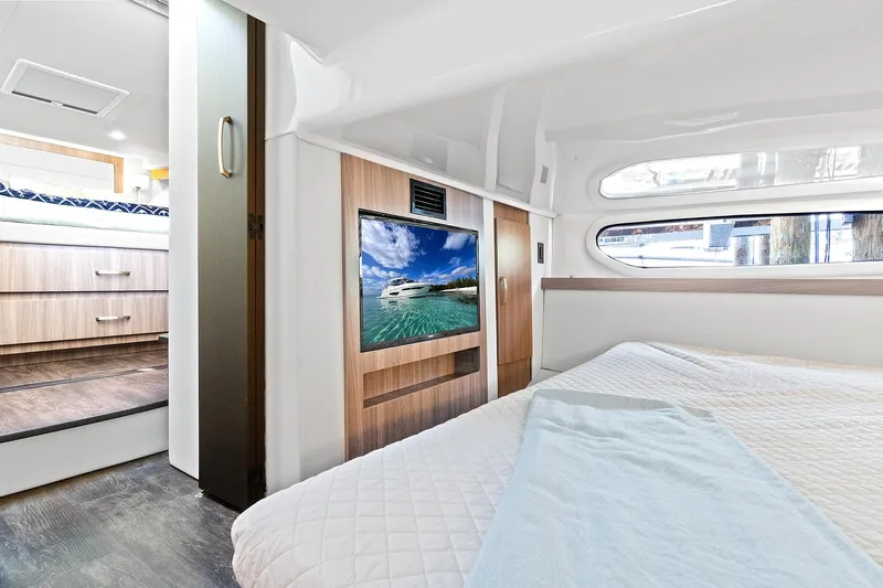 "seadancer" Yacht Photos Pics Interior of 2022 Regal 38 XO yacht with bed, TV, and window view.