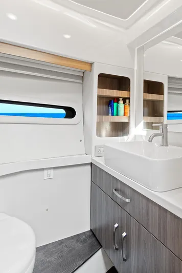 "seadancer" Yacht Photos Pics Modern bathroom interior of 2022 Regal 38 XO yacht, featuring sleek design and ample storage.