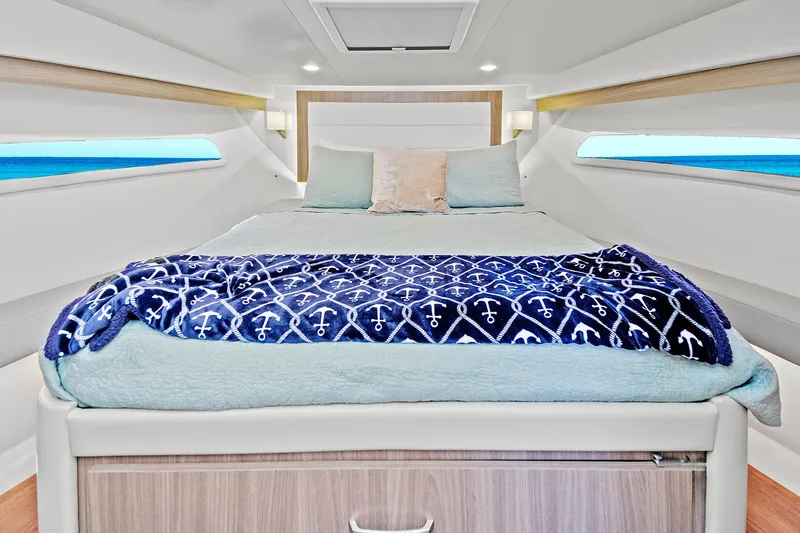 "seadancer" Yacht Photos Pics Luxurious cabin interior of 2022 Regal 38 XO yacht with cozy bedding.