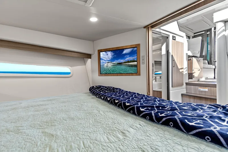 "seadancer" Yacht Photos Pics Interior of 2022 Regal 38 XO yacht with cozy bed and nautical decor.