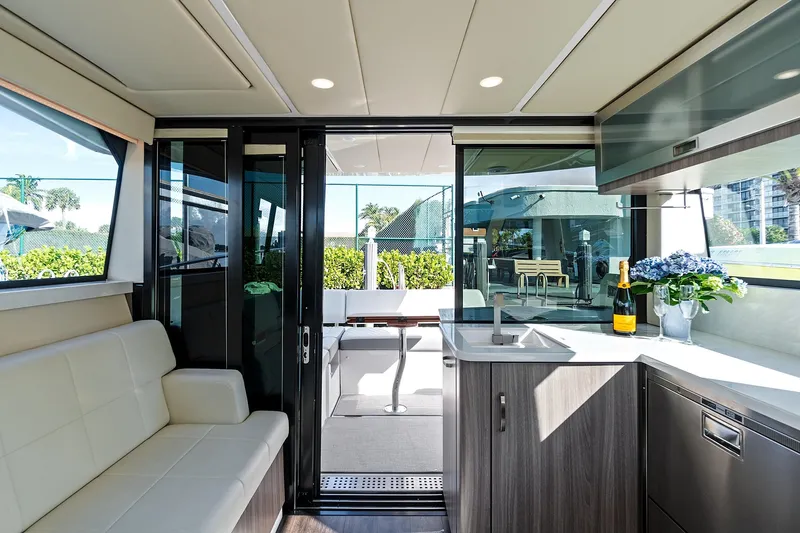 "seadancer" Yacht Photos Pics Luxurious interior of 2022 Regal 38 XO yacht with modern seating and kitchenette.