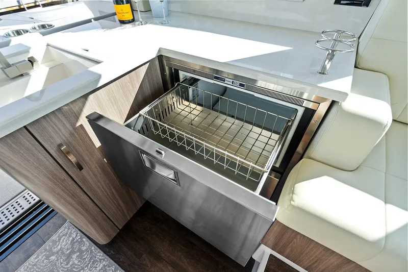 "seadancer" Yacht Photos Pics Open drawer in 2022 Regal 38 XO yacht kitchen, showcasing modern design and functionality.