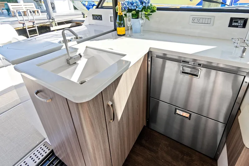 "seadancer" Yacht Photos Pics Modern kitchen area on 2022 Regal 38 XO yacht with sink and stainless appliances.