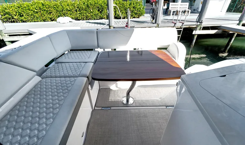 "seadancer" Yacht Photos Pics Luxurious seating area on 2022 Regal 38 XO yacht with elegant table and cushions.
