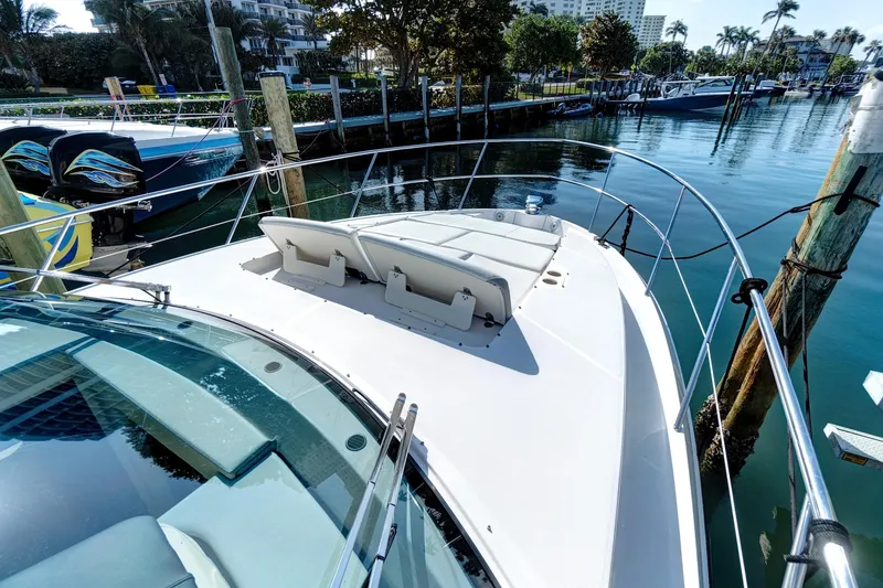 "seadancer" Yacht Photos Pics 2022 Regal 38 XO yacht docked in a marina, featuring a spacious sun deck.
