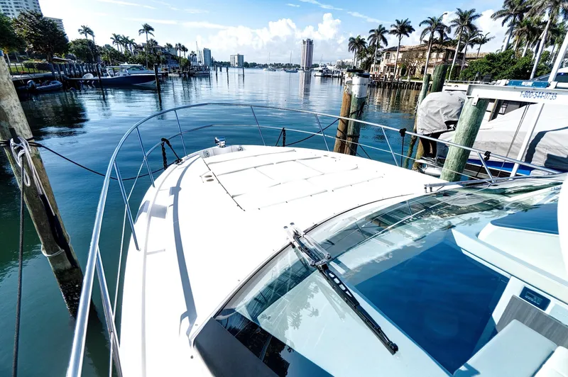 "seadancer" Yacht Photos Pics 2022 Regal 38 XO yacht docked in a scenic marina with palm trees.