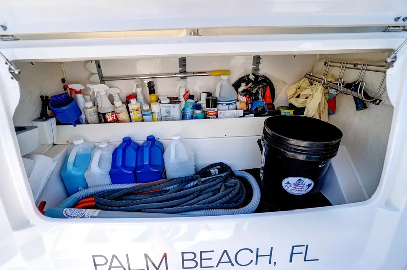 "seadancer" Yacht Photos Pics Storage compartment of 2022 Regal 38 XO boat with cleaning supplies, hoses, and equipment.