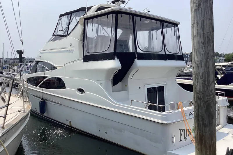 Fun Coupons Yacht Photos Pics 2005 Carver 41 Cockpit Motor Yacht docked at marina, featuring spacious upper deck.