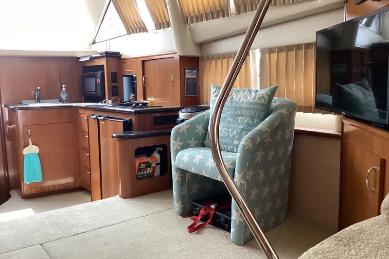 Fun Coupons Yacht Photos Pics Interior of 2005 Carver 41 Cockpit Motor Yacht with kitchen and seating area.