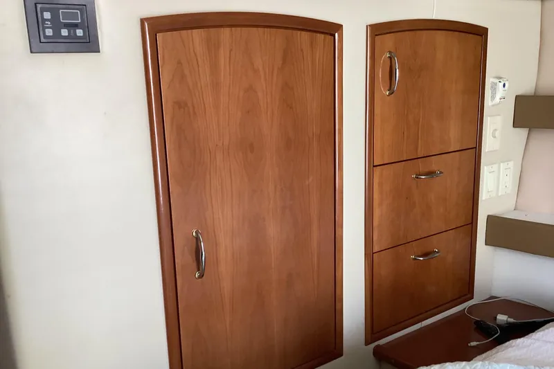 Fun Coupons Yacht Photos Pics 2005 Carver 41 Cockpit Motor Yacht interior with wooden cabinetry and control panel.