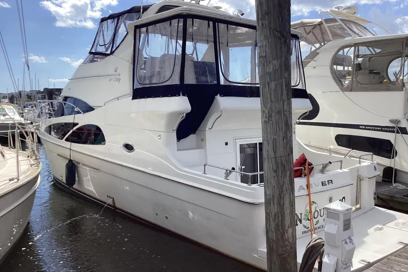 Fun Coupons Yacht Photos Pics 2005 Carver 41 Cockpit Motor Yacht docked at marina, featuring spacious design and elegant lines.
