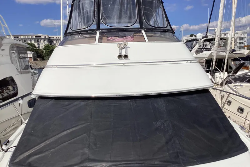 Fun Coupons Yacht Photos Pics 2005 Carver 41 Cockpit Motor Yacht docked at marina under clear blue sky.