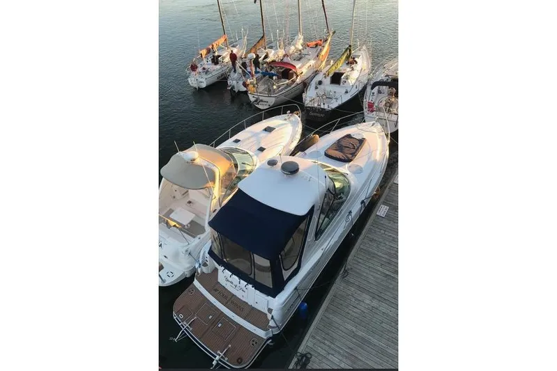 Yacht Photos Pics 2007 Four Winns 278 Vista boat docked among sailboats at a marina.