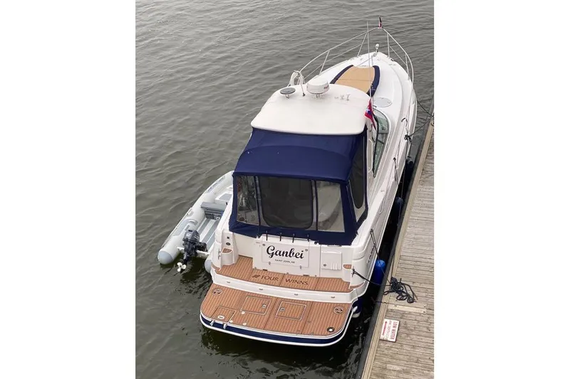  Yacht Photos Pics 2007 Four Winns 278 Vista boat docked with inflatable dinghy attached.