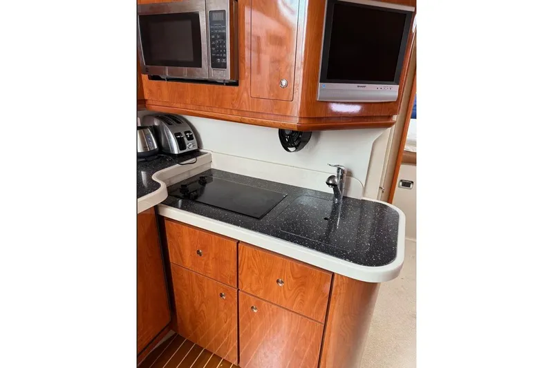 Yacht Photos Pics 2007 Four Winns 278 Vista boat kitchen with microwave, sink, and countertop.