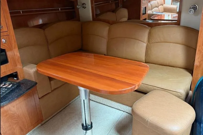  Yacht Photos Pics Interior of 2007 Four Winns 278 Vista boat with leather seating and wooden table.