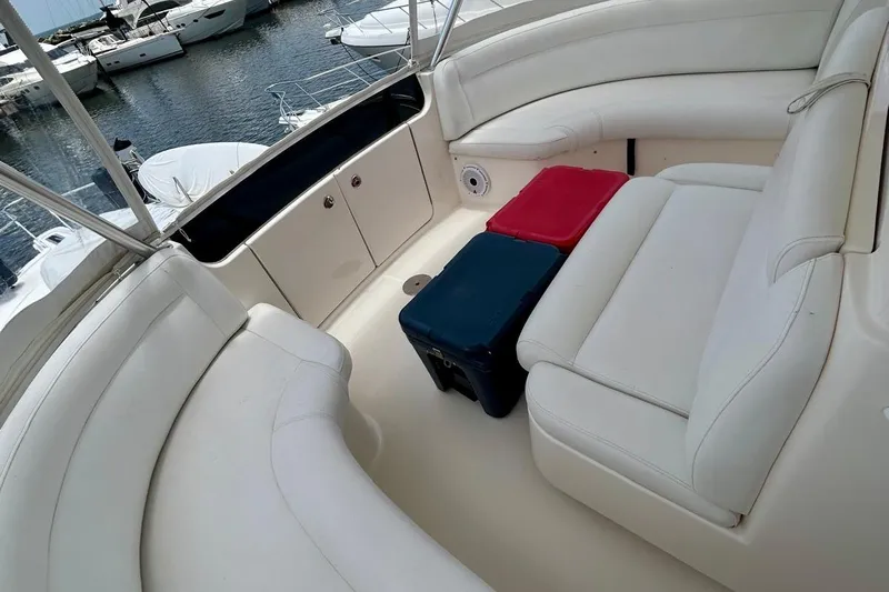 Redeye Yacht Photos Pics Luxurious seating area on a 2012 Tiara Yachts 48 CNV, docked at a marina.