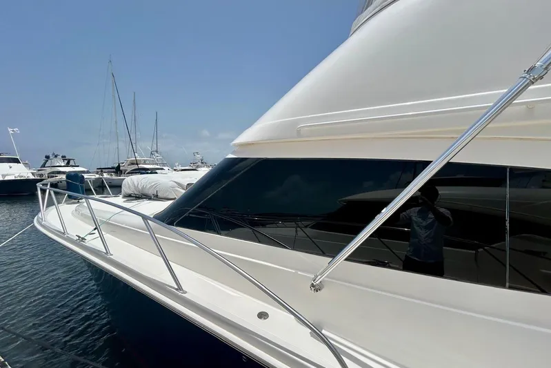 Redeye Yacht Photos Pics 2012 Tiara Yachts 48 CNV docked, showcasing sleek design and reflective windows.