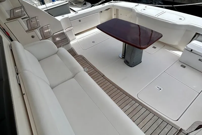Redeye Yacht Photos Pics Luxurious 2012 Tiara Yachts 48 CNV interior with elegant seating and wooden table.