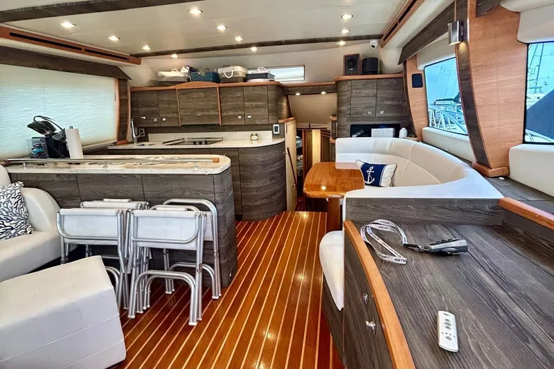 Redeye Yacht Photos Pics Luxurious interior of 2012 Tiara Yachts 48 CNV with modern kitchen and seating area.