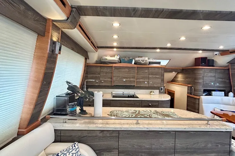 Redeye Yacht Photos Pics Luxurious interior of 2012 Tiara Yachts 48 CNV with modern kitchen and elegant wood finishes.