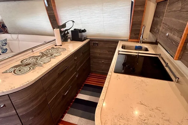 Redeye Yacht Photos Pics Luxurious 2012 Tiara Yachts 48 CNV kitchen with modern countertops and sleek cabinetry.