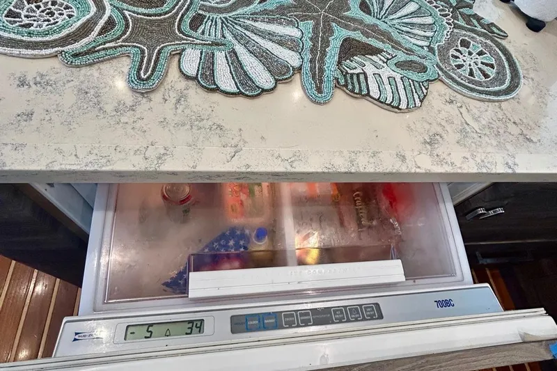 Redeye Yacht Photos Pics Freezer drawer in 2012 Tiara Yachts 48 CNV, with decorative countertop mat.